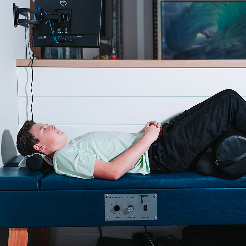 Patient on the AccuSpina spinal decompression table at Foudy Chiropractic