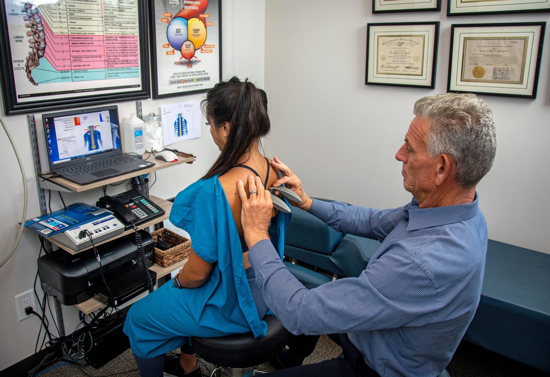 Dr. Foudy reviewing a nervous system scan with a patient