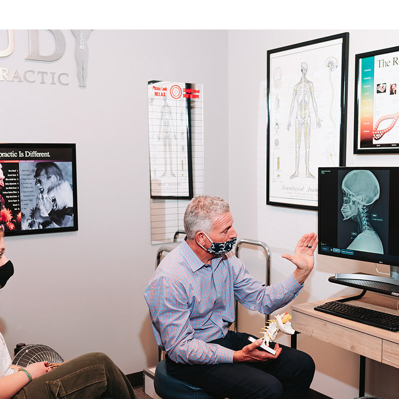 Dr. Foudy explaining exam findings to a patient